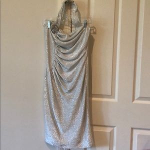 Cocktail dress. Shiny silver/jeweled brooch wrap